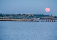 Strawberry moon over Pleasure Bay in South Boston