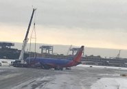 Plane and crane at Logan Airport