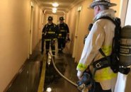 Firefighters in Hawthorne Place hallway