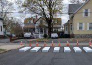 Apparent concrete blocks at exit of Brooks School parking lot