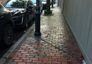 Electric-car charging cord on sidewalk