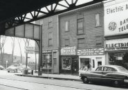 Street scene under an el in old Boston