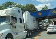 Truck wedged under an Orange Street bridge in Malden