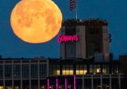 Moon sets over the Schrafft's Building in Charlestown