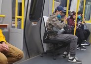 Guy in a chair on the Orange Line