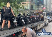 Police, tow worker getting scooters ready for transport somewhere else