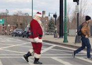 Santa crossing Washington Street to the Forest Hills T station