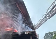 Firefighter, ladder at smoky house on Tip Top Street