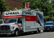 U-Haul with its roof peeled back by the North Harvard Street Bridge