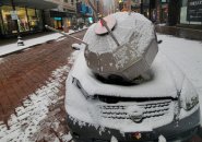 Satellite and smashed car on Washington Street downtown in the snow