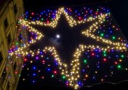 Moon and Venus seen through an illuminated star above Downtown Crossing