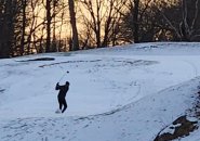 Fore! Golfer tees off in the snow at George Wright today