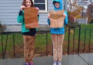 Two kids with pro trans rights signs