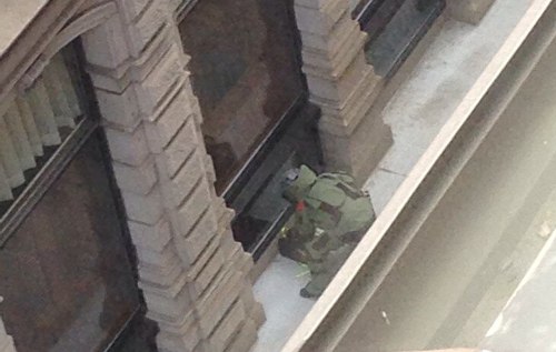 Bomb squad member investigates backpack