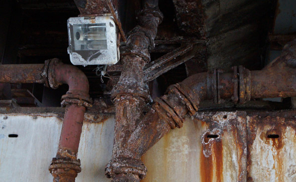 Rusty pipes under the overpass