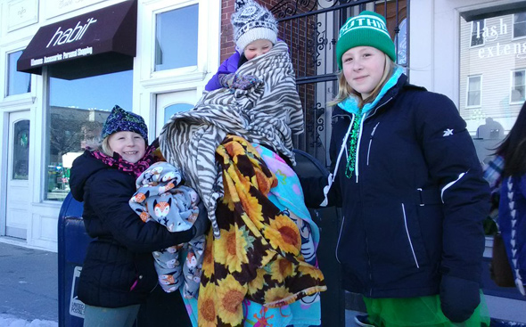 Girls bundled up at the St. Patrick's parade in South Boston