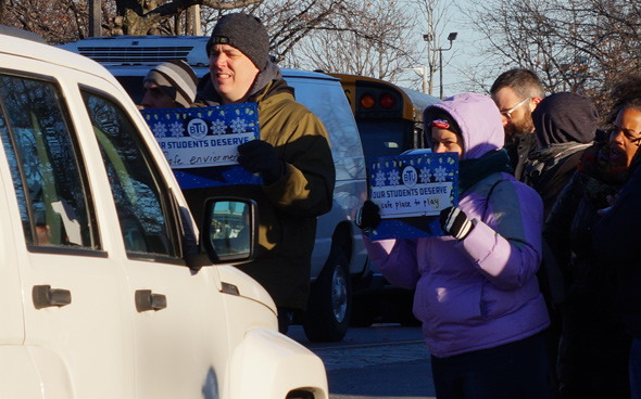 Teachers with signs outside Orchard Gardens School